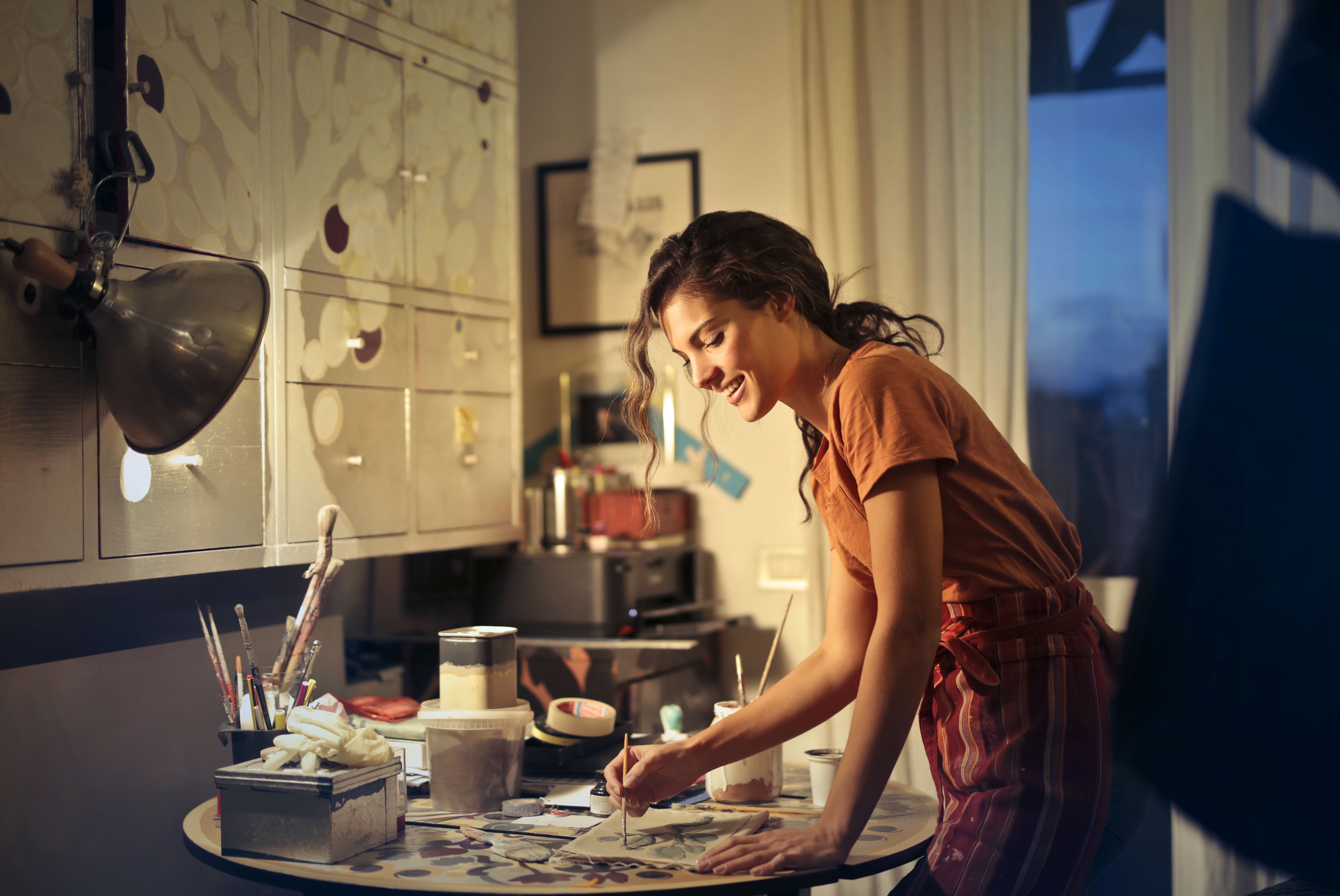 Woman painting in warm studio